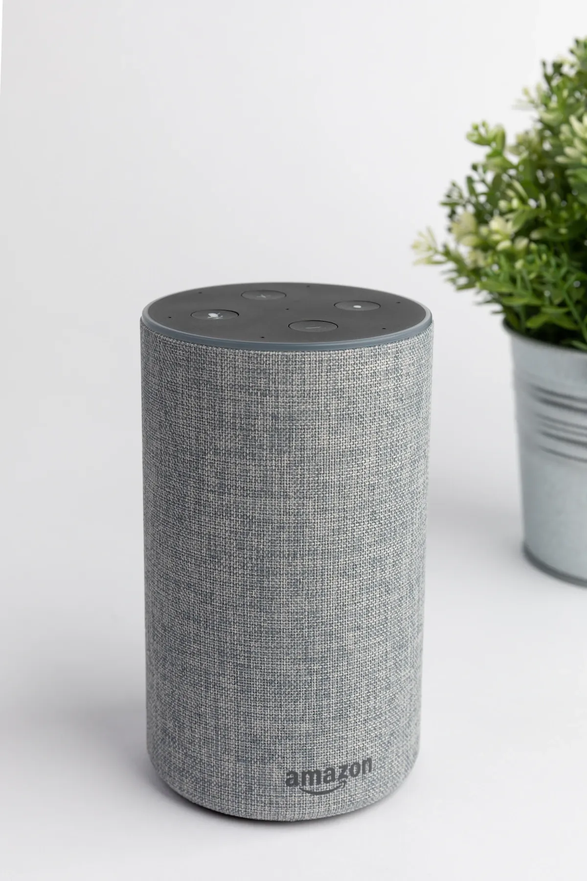 Smart speaker on a wooden surface representing voice assistants like Alexa, Siri, and Google Assistant